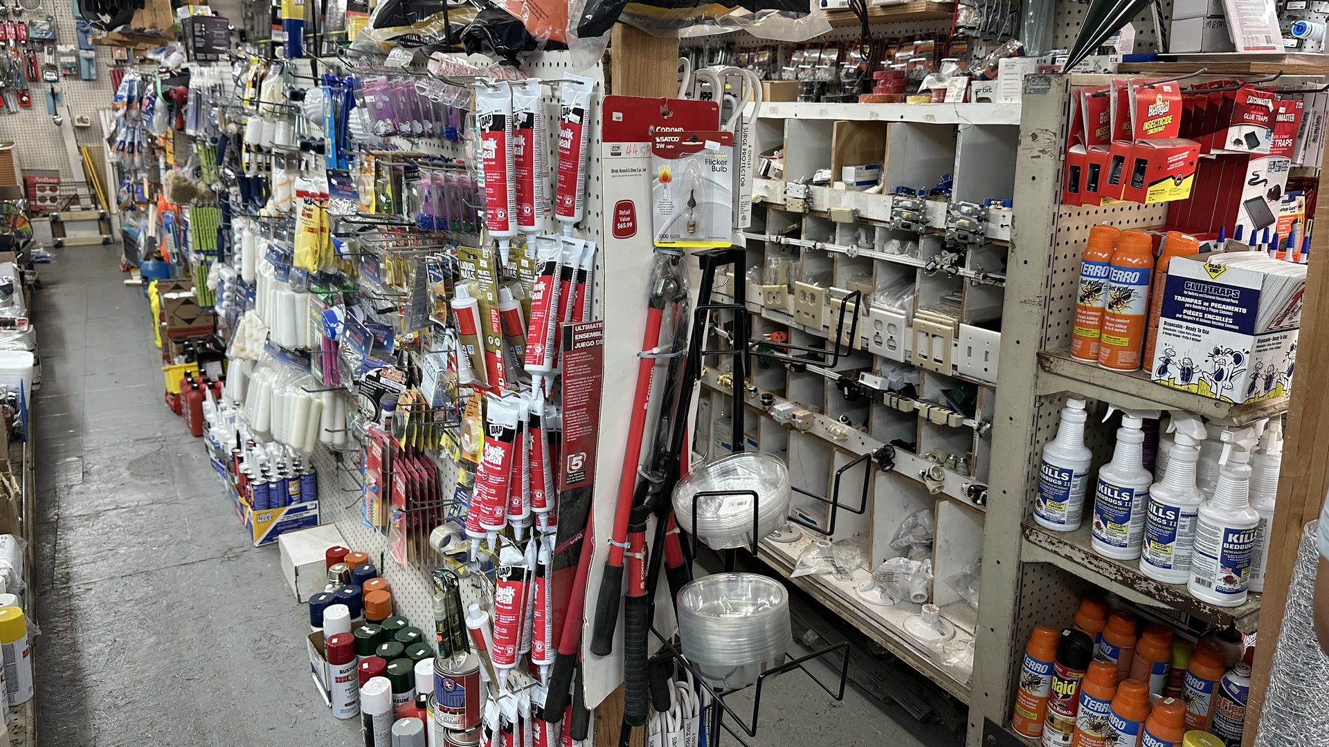 Inside SBS Hardware — packed aisles of tools, hardware, and home repair supplies